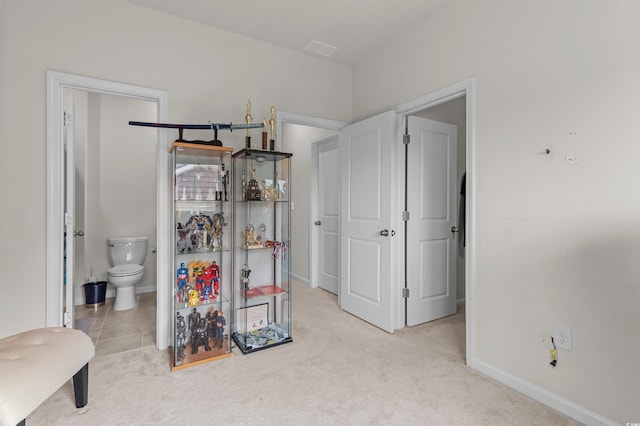 1176 Harbison Cir, Myrtle Beach, SC 29579 - bedroom with connected bathroom, baseboards, and light carpet