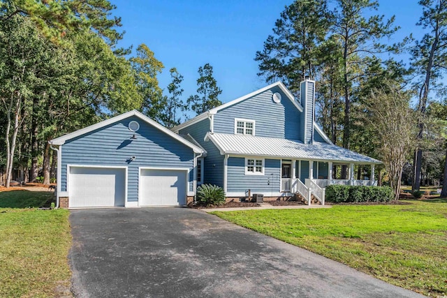 160 Shipmaster Ave, Pawleys Island, SC 29585 - view of front of property with a porch, driveway, an attached garage, and a front lawn