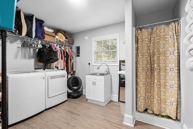 160 Shipmaster Ave, Pawleys Island, SC 29585 - washroom with independent washer and dryer, cabinet space, and light wood-style floors