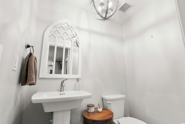 160 Shipmaster Ave, Pawleys Island, SC 29585 - bathroom with toilet, a chandelier, and a sink