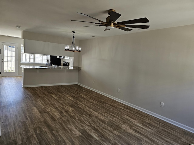 703 S 1st Ave S Unit 34D, North Myrtle Beach, SC 29582 - unfurnished living room with baseboards, a chandelier, dark wood-type flooring, ceiling fan, and a sink