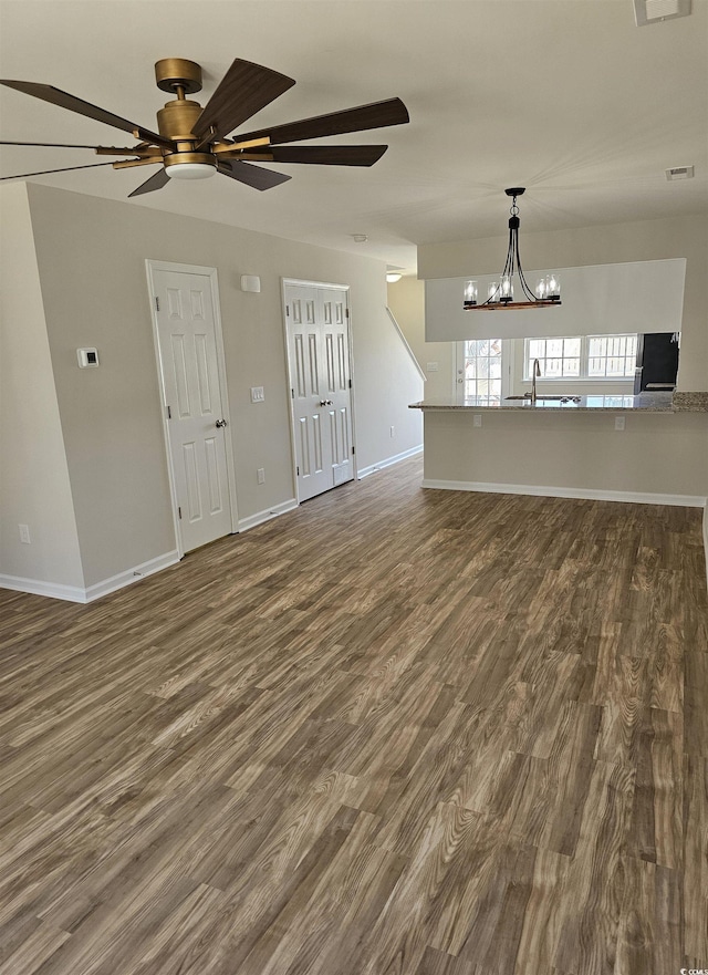 703 S 1st Ave S Unit 34D, North Myrtle Beach, SC 29582 - unfurnished living room with a chandelier, dark wood finished floors, ceiling fan, and baseboards