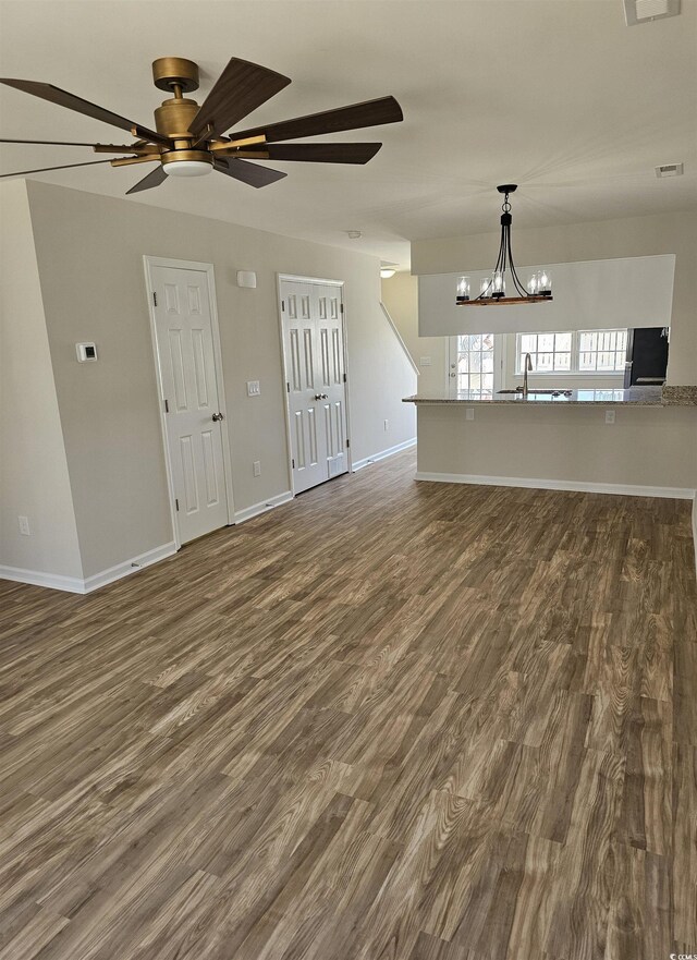 703 S 1st Ave S Unit 34D, North Myrtle Beach, SC 29582 - unfurnished living room with a chandelier, dark wood finished floors, ceiling fan, and baseboards