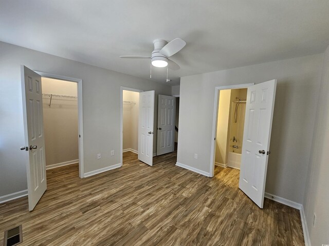 703 S 1st Ave S Unit 34D, North Myrtle Beach, SC 29582 - unfurnished bedroom with dark wood-style flooring, baseboards, and a spacious closet