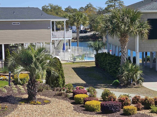 703 S 1st Ave S Unit 34D, North Myrtle Beach, SC 29582 - view of yard with stairs, fence, and a water view