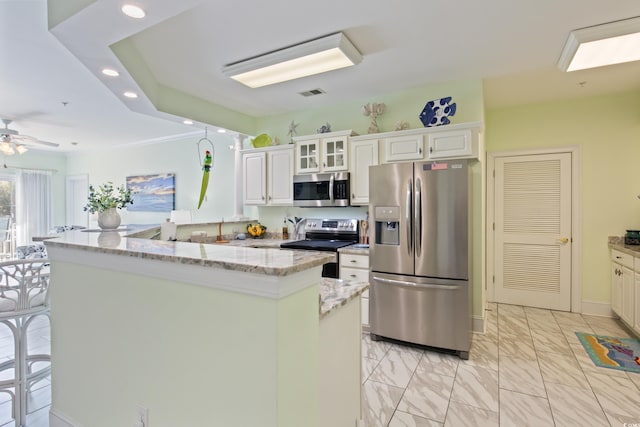 2180 Waterview Dr Unit 733, North Myrtle Beach, SC 29582 - kitchen featuring appliances with stainless steel finishes, a kitchen island, recessed lighting, light marble finish flooring, and white cabinetry