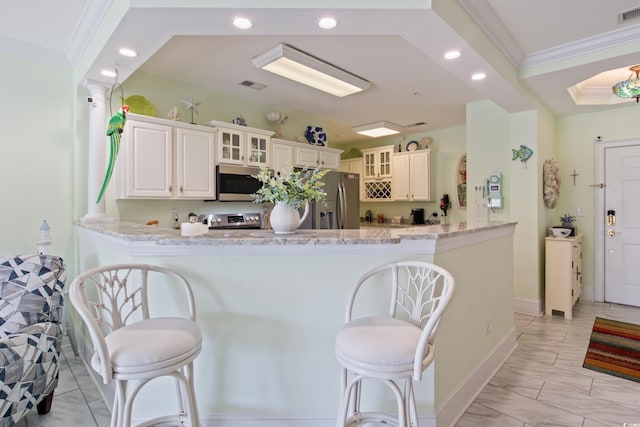 2180 Waterview Dr Unit 733, North Myrtle Beach, SC 29582 - kitchen featuring stainless steel appliances, a peninsula, a breakfast bar, light stone countertops, and recessed lighting