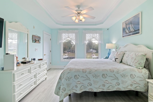 2180 Waterview Dr Unit 733, North Myrtle Beach, SC 29582 - bedroom with a tray ceiling, light wood-type flooring, ornamental molding, a ceiling fan, and baseboards