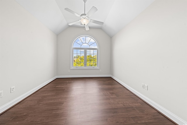 unfurnished room with dark wood finished floors, baseboards, a ceiling fan, and vaulted ceiling
