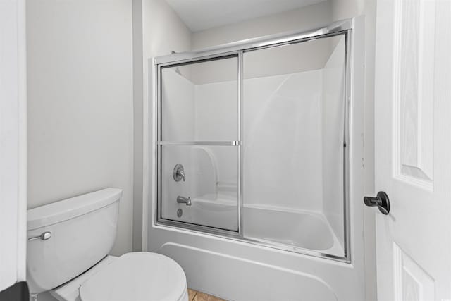 full bathroom with toilet and enclosed tub / shower combo