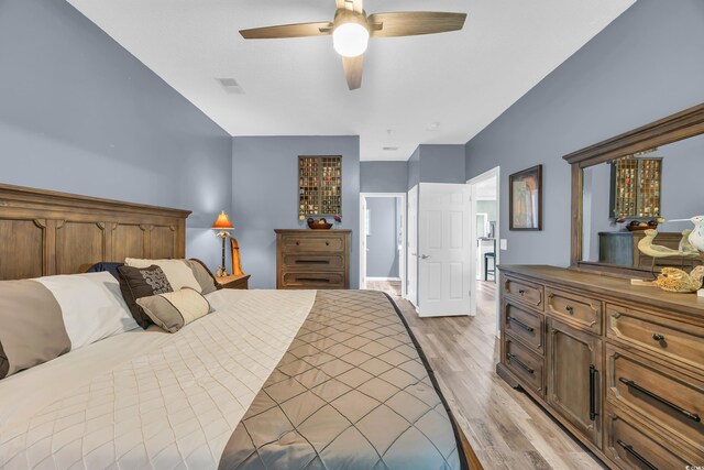 bedroom featuring visible vents, ceiling fan, and light wood-type flooring