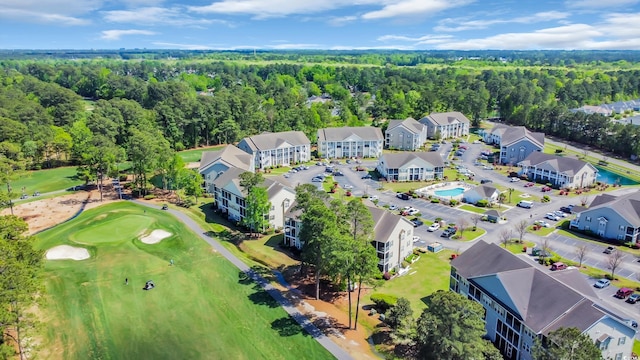 drone / aerial view with a view of trees and golf course view