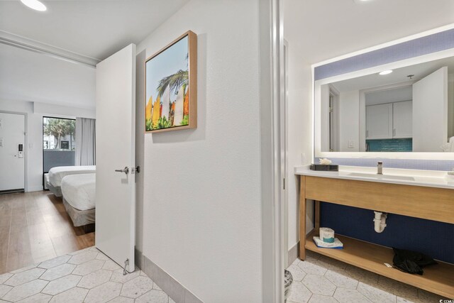 3000 N Ocean Blvd Unit 130, Myrtle Beach, SC 29577 - ensuite bathroom with tile patterned floors, ensuite bath, vanity, and baseboards