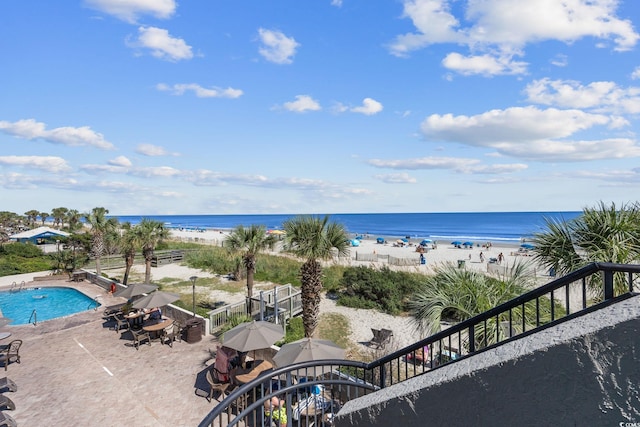 water view featuring local beach and fence