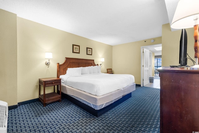 carpeted bedroom with baseboards