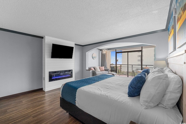 6900 N Ocean Blvd Unit 404, Myrtle Beach, SC 29572 - bedroom with dark wood-style flooring, a fireplace, a textured ceiling, ornamental molding, and arched walkways