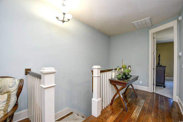 4850 Cantor Ct Unit 202, North Myrtle Beach, SC 29582 - hallway featuring an upstairs landing, wood-type flooring, and baseboards