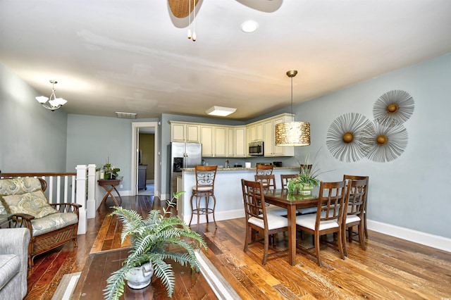 4850 Cantor Ct Unit 202, North Myrtle Beach, SC 29582 - dining area featuring wood-type flooring, baseboards, a ceiling fan, and a chandelier