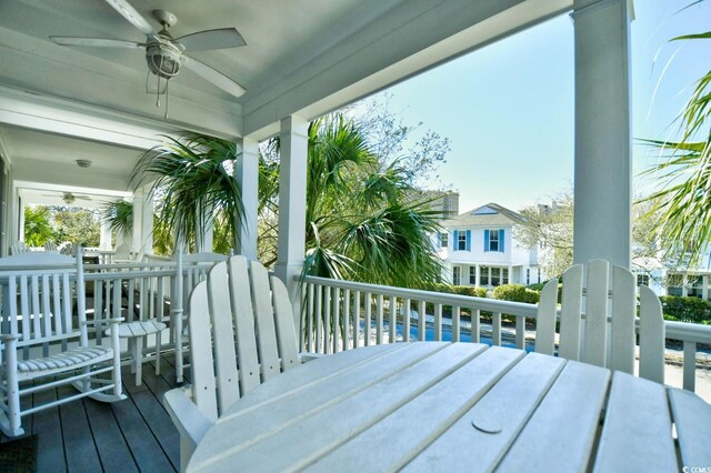 4850 Cantor Ct Unit 202, North Myrtle Beach, SC 29582 - wooden deck featuring ceiling fan and outdoor dining area