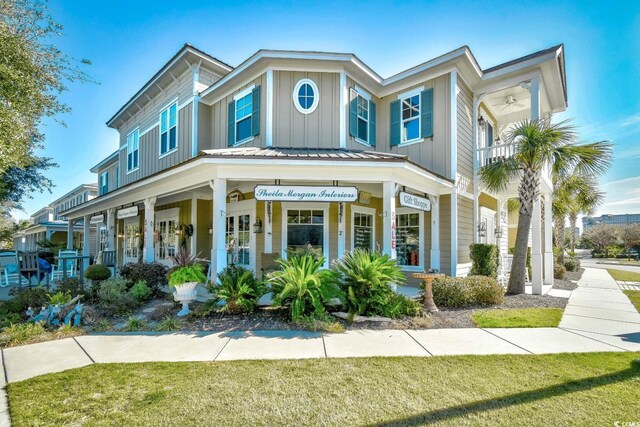 4850 Cantor Ct Unit 202, North Myrtle Beach, SC 29582 - view of front of property featuring board and batten siding, a porch, a front yard, and metal roof