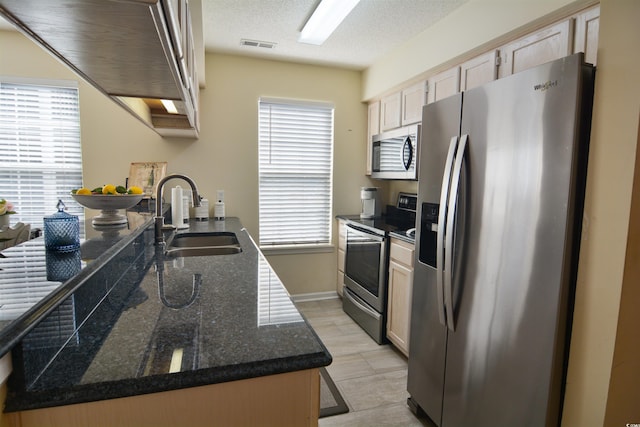 5030 Windsor Green Way Unit 203, Myrtle Beach, SC 29579 - kitchen with a textured ceiling, a sink, appliances with stainless steel finishes, visible vents, and baseboards