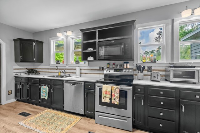 532 Medcalf Dr SW, Sunset Beach, NC 28468 - kitchen featuring light countertops, a sink, appliances with stainless steel finishes, and dark cabinets