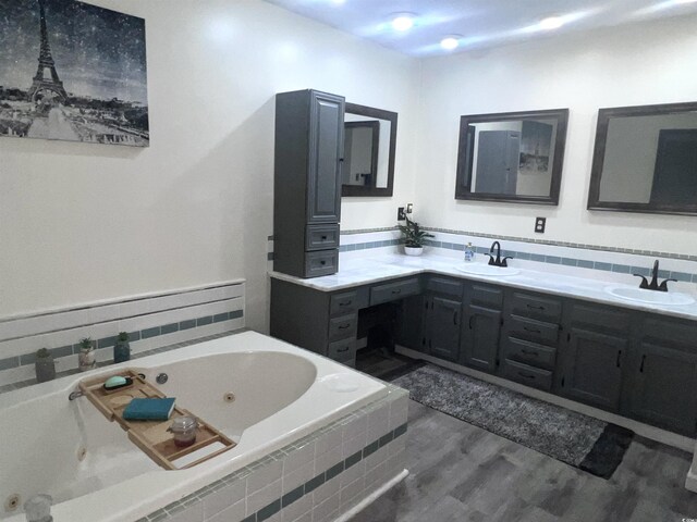 532 Medcalf Dr SW, Sunset Beach, NC 28468 - bathroom featuring double vanity, a sink, a tub with jets, and wood finished floors