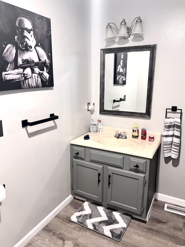 532 Medcalf Dr SW, Sunset Beach, NC 28468 - bathroom featuring wood finished floors, vanity, baseboards, and visible vents