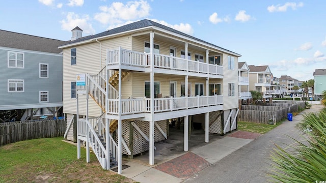 412 Seaside Dr S, Surfside Beach, SC 29575 - back of property with stairway, driveway, and a residential view