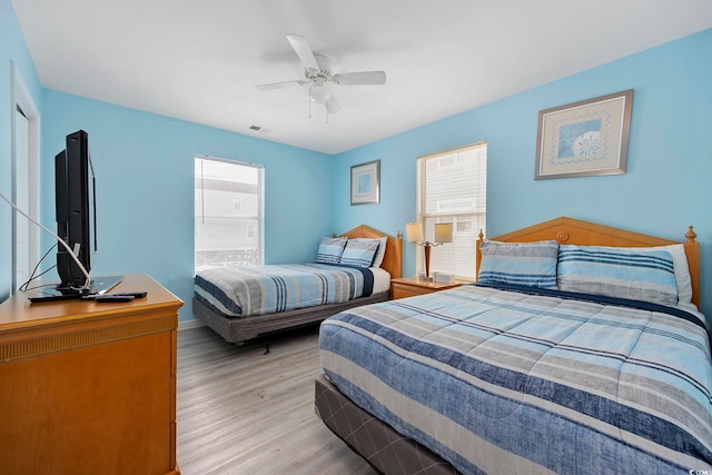 412 Seaside Dr S, Surfside Beach, SC 29575 - bedroom with light wood-style floors and ceiling fan