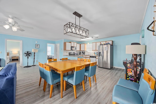 412 Seaside Dr S, Surfside Beach, SC 29575 - dining room featuring light wood-style floors, a ceiling fan, and baseboards