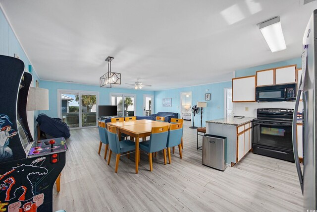 412 Seaside Dr S, Surfside Beach, SC 29575 - dining area with light wood-style flooring and a ceiling fan