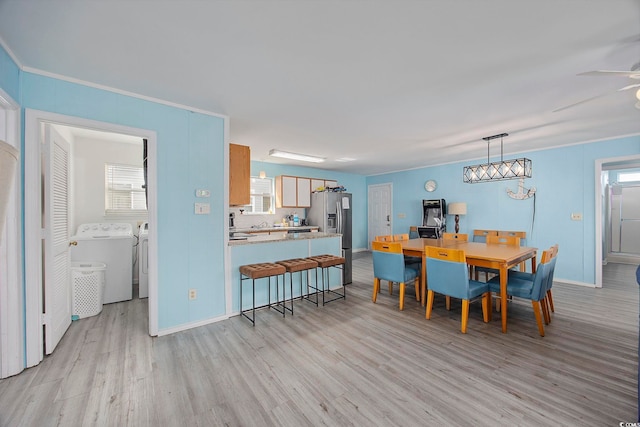 412 Seaside Dr S, Surfside Beach, SC 29575 - dining area with independent washer and dryer, light wood-type flooring, baseboards, and ceiling fan