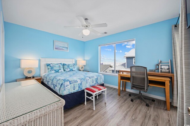 412 Seaside Dr S, Surfside Beach, SC 29575 - bedroom with wood finished floors, baseboards, a desk, and a ceiling fan