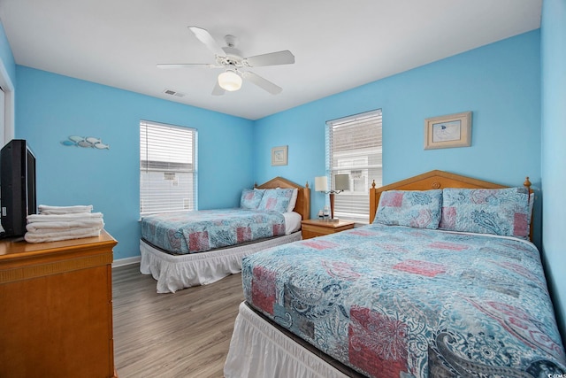 412 Seaside Dr S, Surfside Beach, SC 29575 - bedroom featuring wood finished floors, ceiling fan, and baseboards
