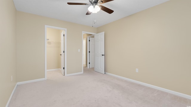 4533 Greenbriar Dr, Little River, SC 29566 - unfurnished bedroom featuring a closet, baseboards, ceiling fan, a walk in closet, and light colored carpet