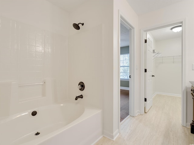 4533 Greenbriar Dr, Little River, SC 29566 - full bath featuring baseboards, a walk in closet, shower / washtub combination, and wood finished floors