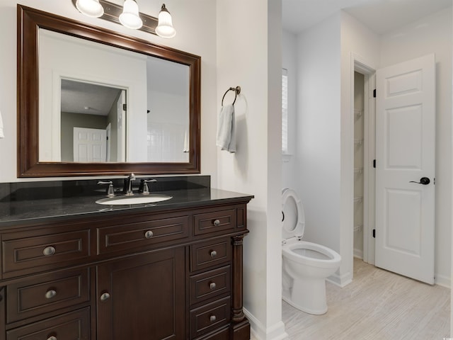 4533 Greenbriar Dr, Little River, SC 29566 - bathroom with toilet, baseboards, vanity, and wood finished floors