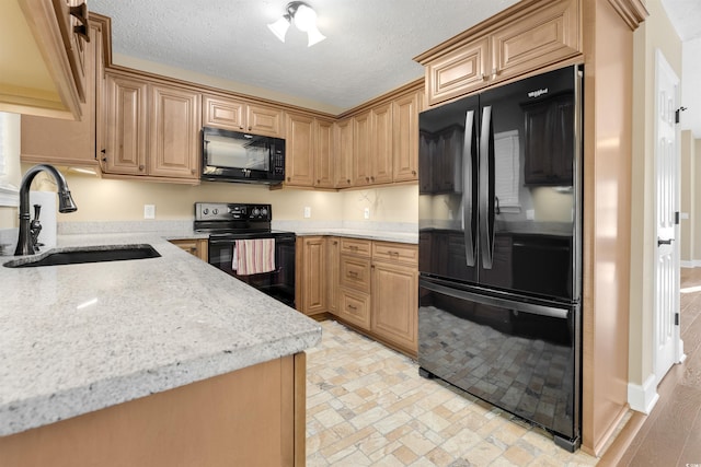 4533 Greenbriar Dr, Little River, SC 29566 - kitchen featuring a sink, black appliances, light stone counters, and a textured ceiling