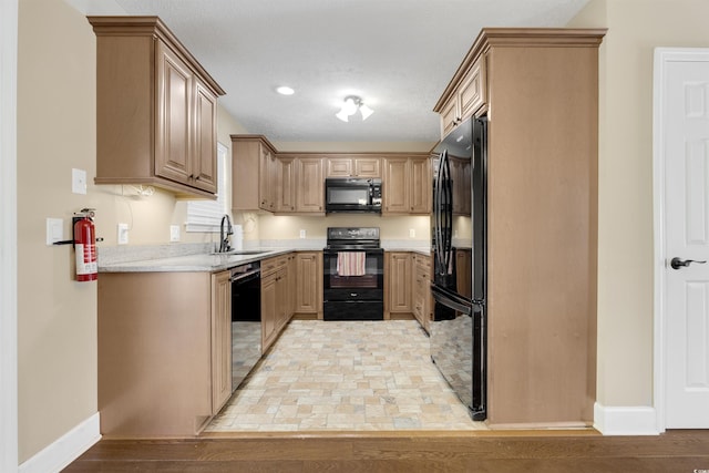 4533 Greenbriar Dr, Little River, SC 29566 - kitchen featuring baseboards, light countertops, black appliances, light wood-style floors, and a sink