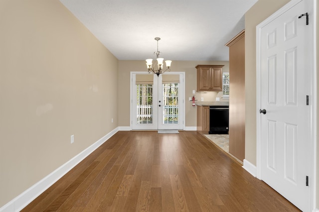 4533 Greenbriar Dr, Little River, SC 29566 - unfurnished dining area featuring dark wood-style floors, baseboards, and an inviting chandelier