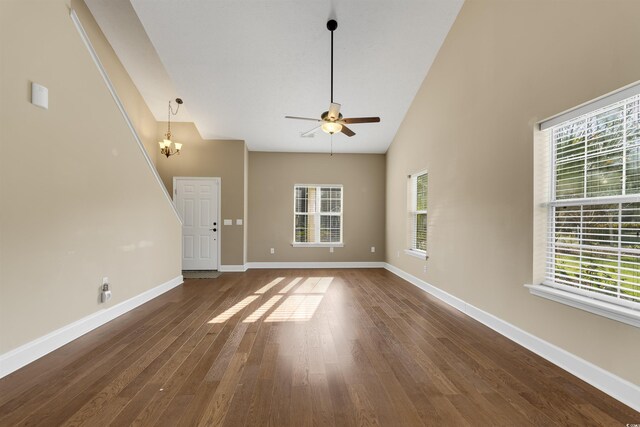 4533 Greenbriar Dr, Little River, SC 29566 - unfurnished living room with ceiling fan with notable chandelier, baseboards, and a wealth of natural light