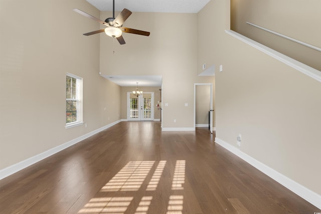 4533 Greenbriar Dr, Little River, SC 29566 - unfurnished living room featuring baseboards, high vaulted ceiling, wood finished floors, and ceiling fan with notable chandelier