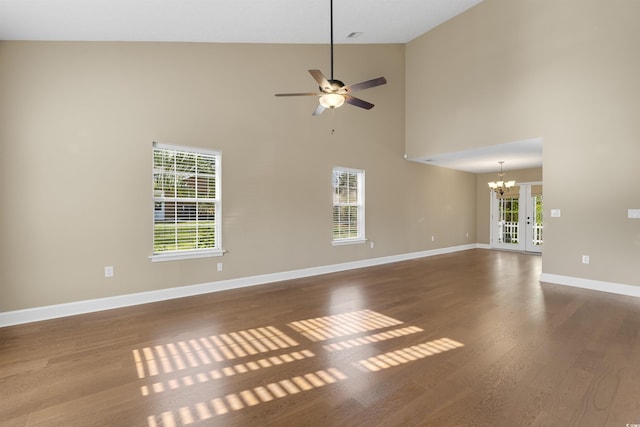 4533 Greenbriar Dr, Little River, SC 29566 - unfurnished living room with baseboards, high vaulted ceiling, wood finished floors, and ceiling fan with notable chandelier