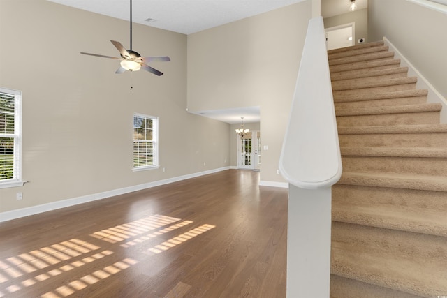 4533 Greenbriar Dr, Little River, SC 29566 - interior space featuring wood finished floors, ceiling fan with notable chandelier, a towering ceiling, and baseboards