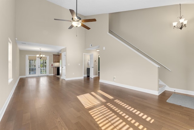 4533 Greenbriar Dr, Little River, SC 29566 - unfurnished living room featuring ceiling fan with notable chandelier, high vaulted ceiling, baseboards, and dark wood-style flooring