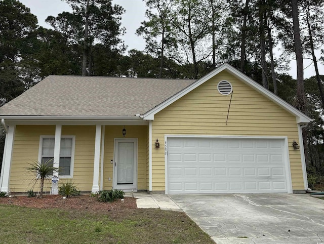 4533 Greenbriar Dr, Little River, SC 29566 - view of front facade featuring an attached garage, a shingled roof, and driveway