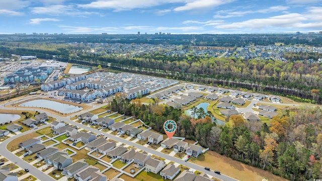 aerial overview of property's location featuring a nearby body of water and nearby suburban area
