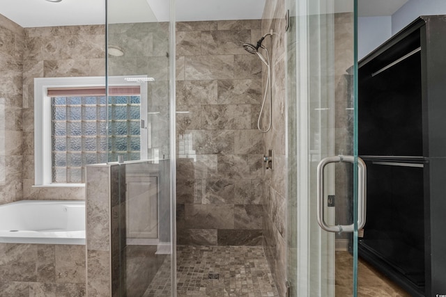 bathroom featuring a garden tub and a stall shower