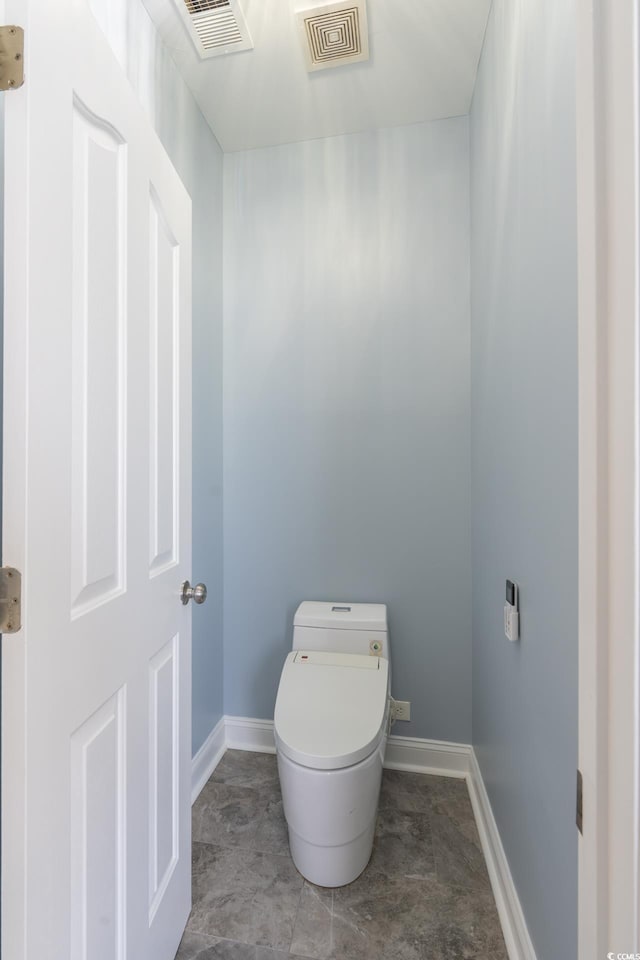 bathroom with visible vents, baseboards, and toilet